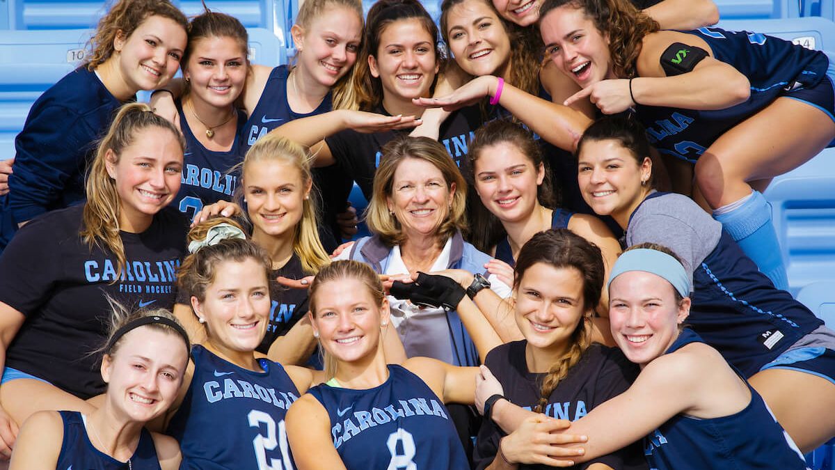 UNC Field Hockey Coach Karen Shelton sits in the middle of her team