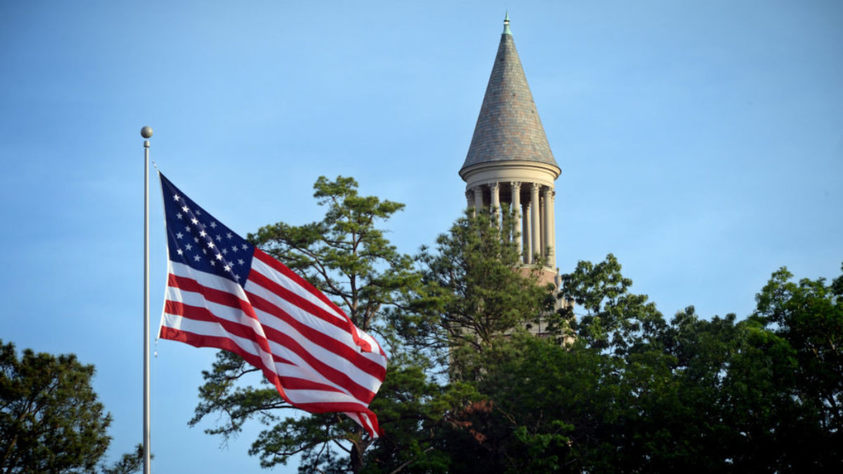 American flag with the Carolina bell tower in the background.