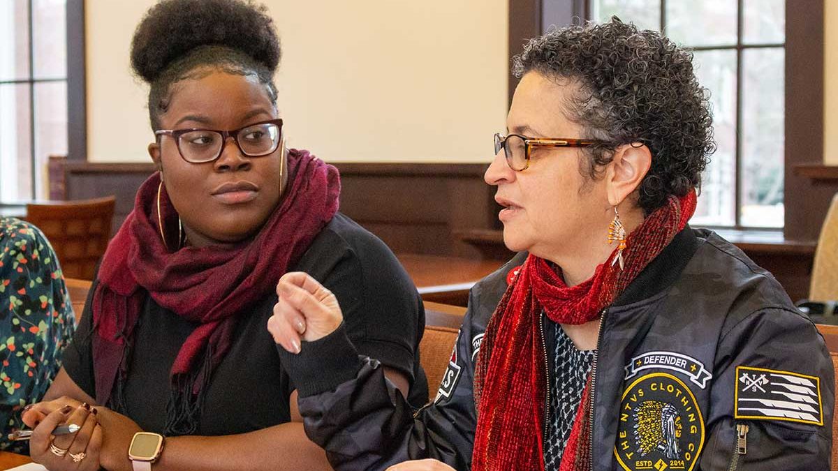 Diamond Holloman, a PhD candidate at UNC-Chapel Hill, listens to Malinda Maynor Lowery, co-director of Southern futures at a meeting in a community center in Robeson County.