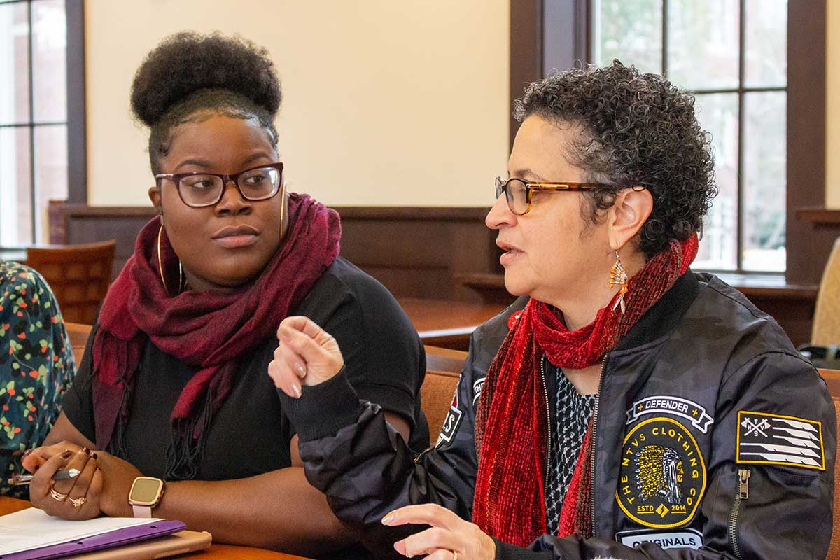 Diamond Holloman, a PhD candidate at UNC-Chapel Hill, listens to Malinda Maynor Lowery, co-director of Southern futures at a meeting in a community center in Robeson County.
