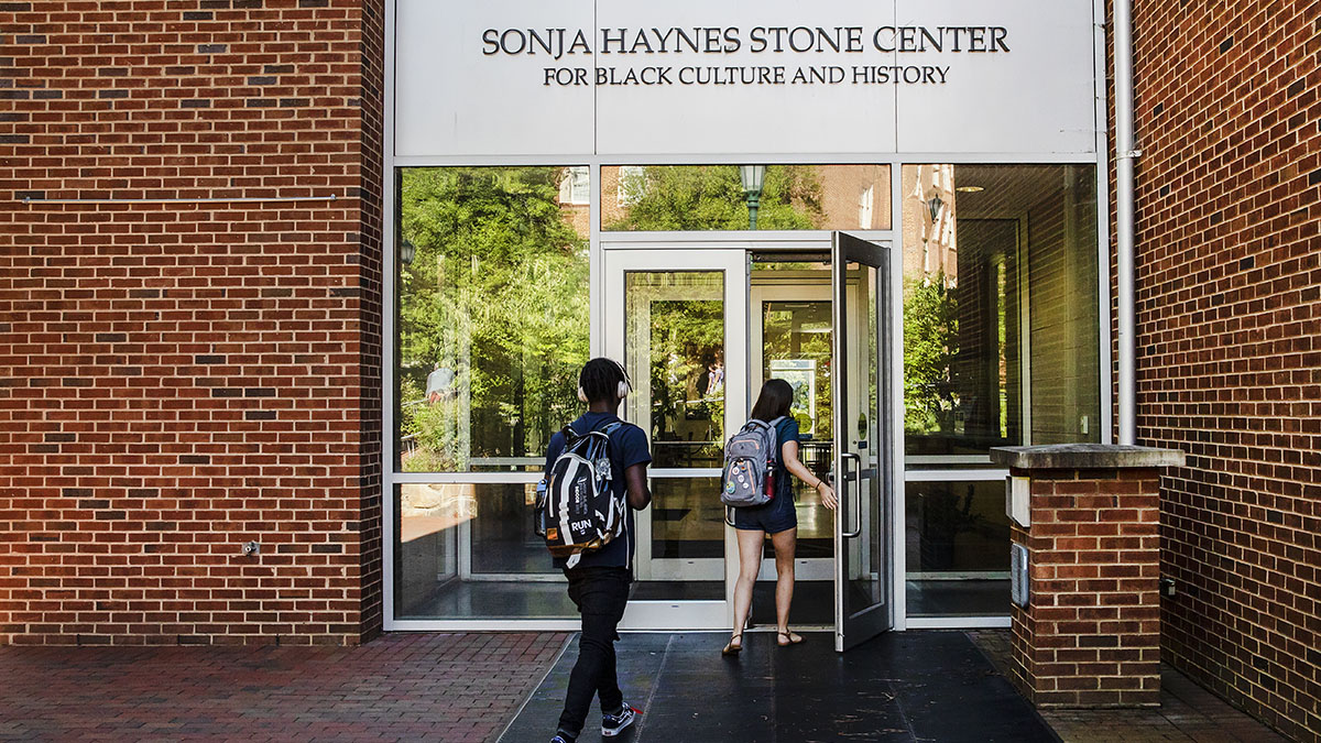 Two students walk into the Sonja Hayes Stone Center building.