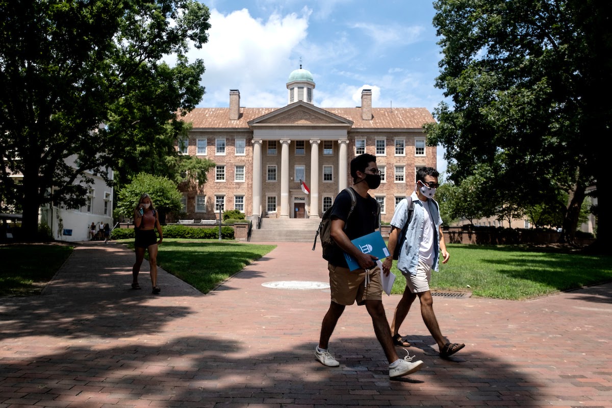 Two students walking on campus.