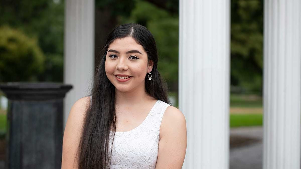 Maria Tiznado poses in front of the Old Well on UNC-Chapel Hill's campus.