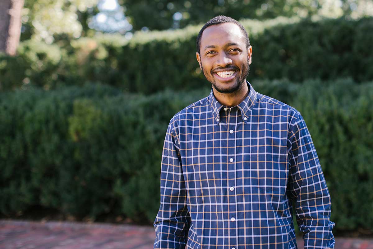 Carolina Covenant Scholar Fidele Mugisha poses on campus at UNC-Chapel Hill.