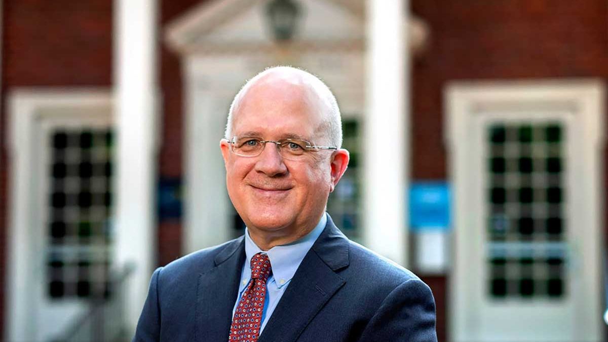 Former vice provost Stephen Farmer poses in front of a building on the campus of UNC-Chapel Hill.