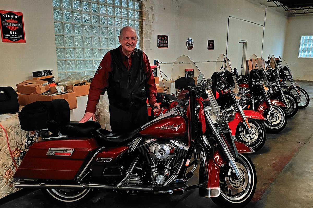 Law School alumnus Douglas Freedle stands with his collection of Harley Davidson motorcycles.