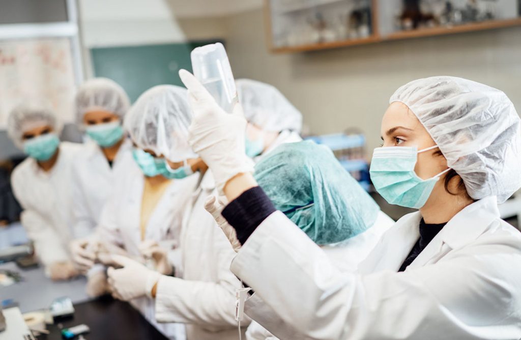 Pharmacists practicing to administer a vaccine.