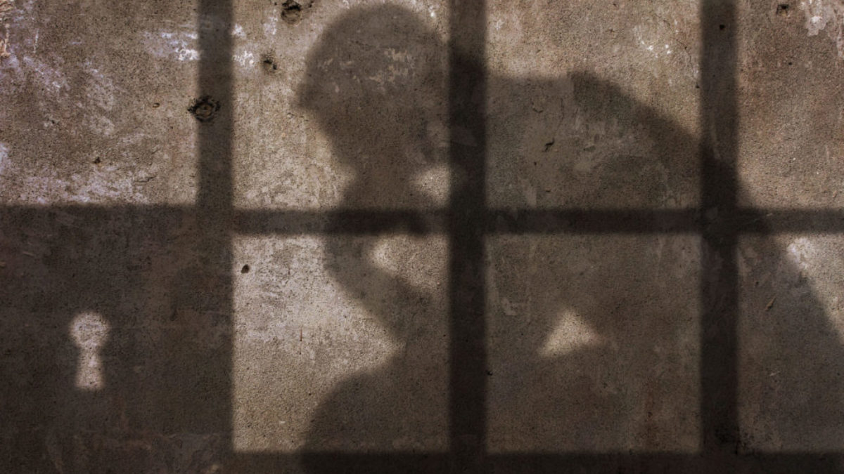 Silhouette of person in prison
