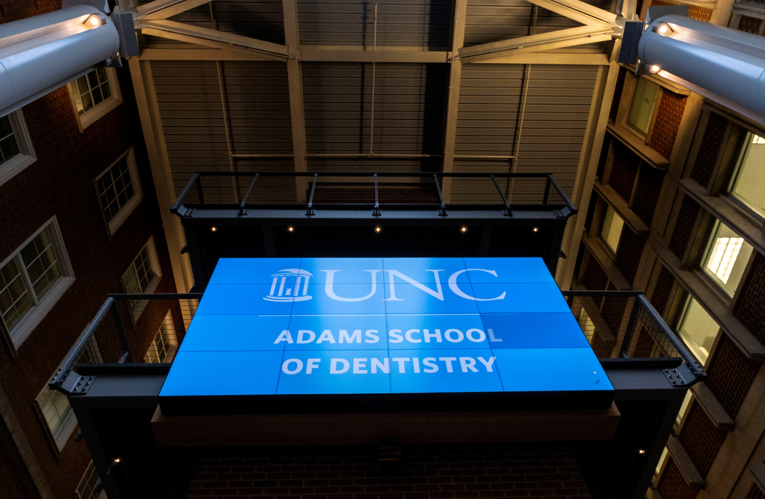 Sign unveiling the new name of the UNC School of Dentistry. It reads 