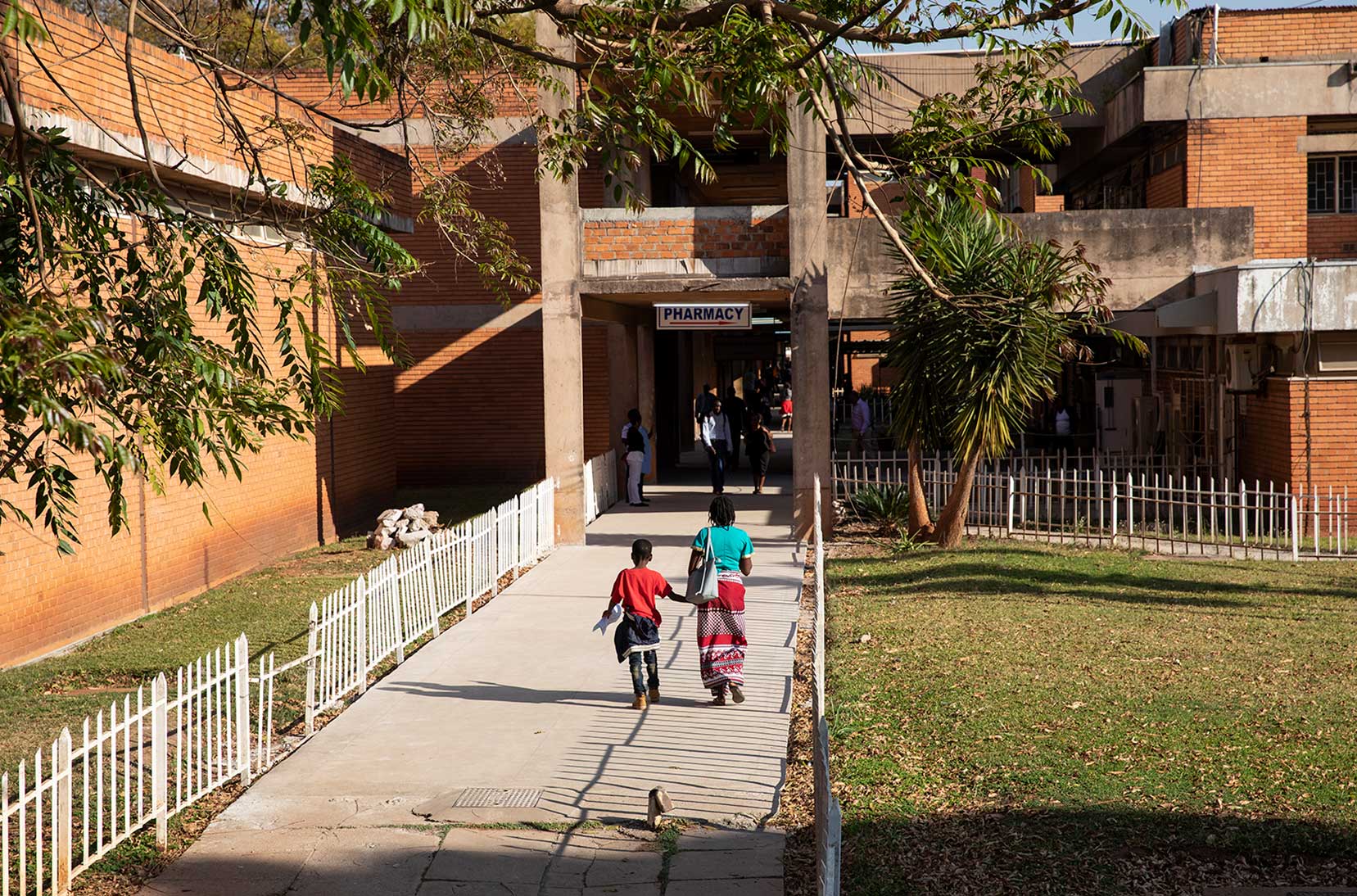 Patients walk into the University of Zambia School of Medicine Teaching Hospital in Lusaka, Zambia.