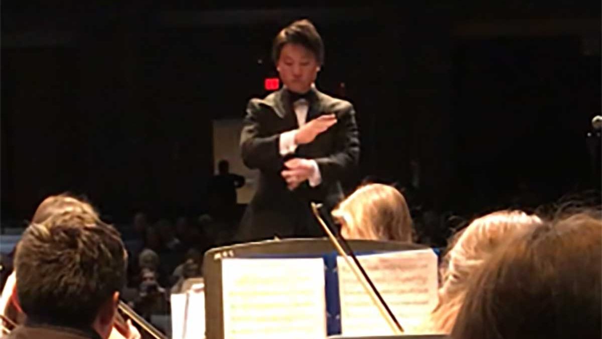 Carolina alumnus Will Jung conducts an orchestra.
