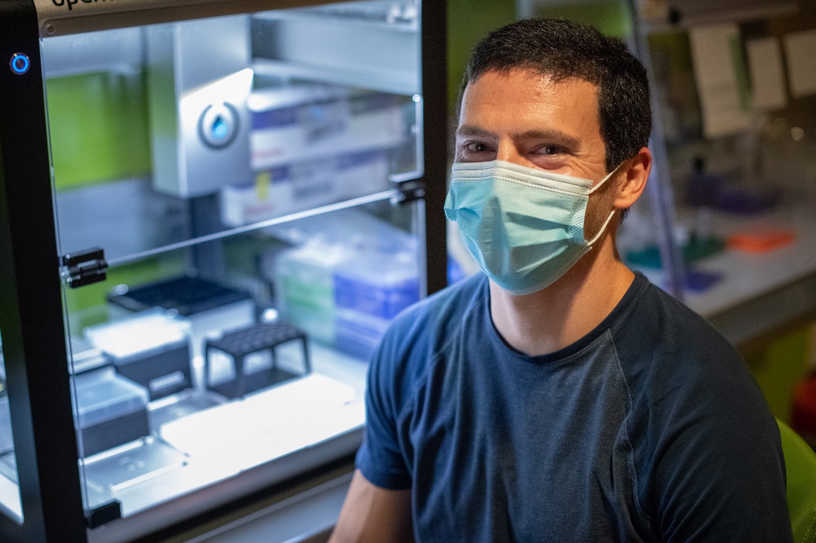 Jeremy Wang, assistant professor of genetics in the UNC School of Medicine, in front of lab equipment