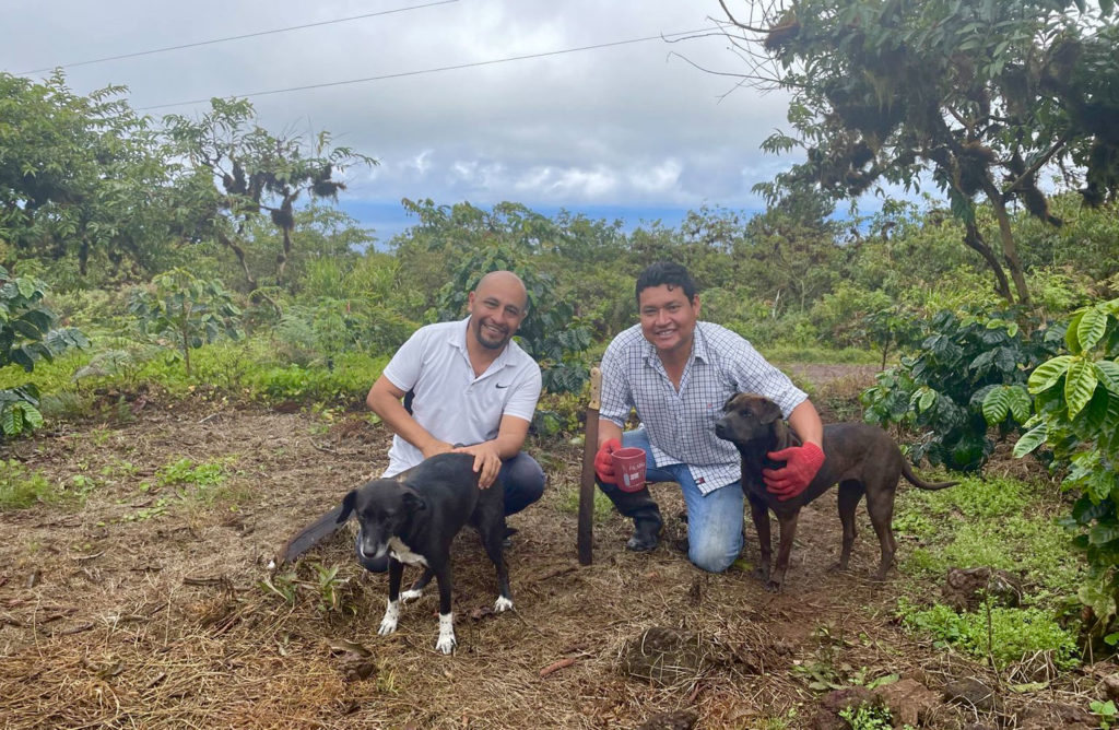 Nicolas and Jairo with all they need for a successful day – coffee, dogs and their machetes.