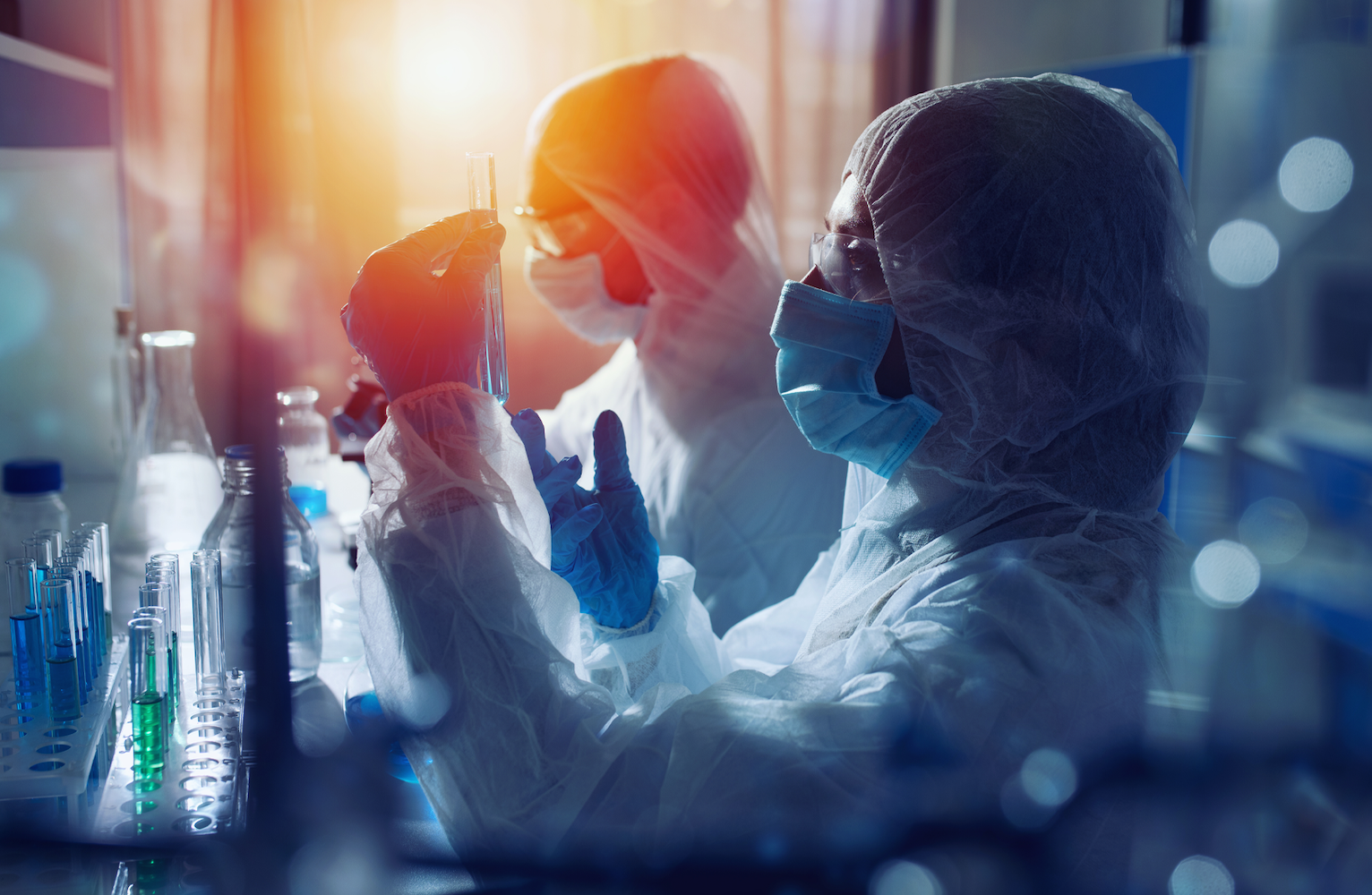 Two scientists look at test tubes