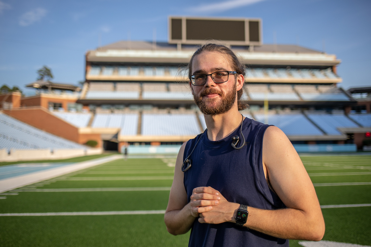 Matthew Wood poses with Kenan Memorial Stadium in the background.