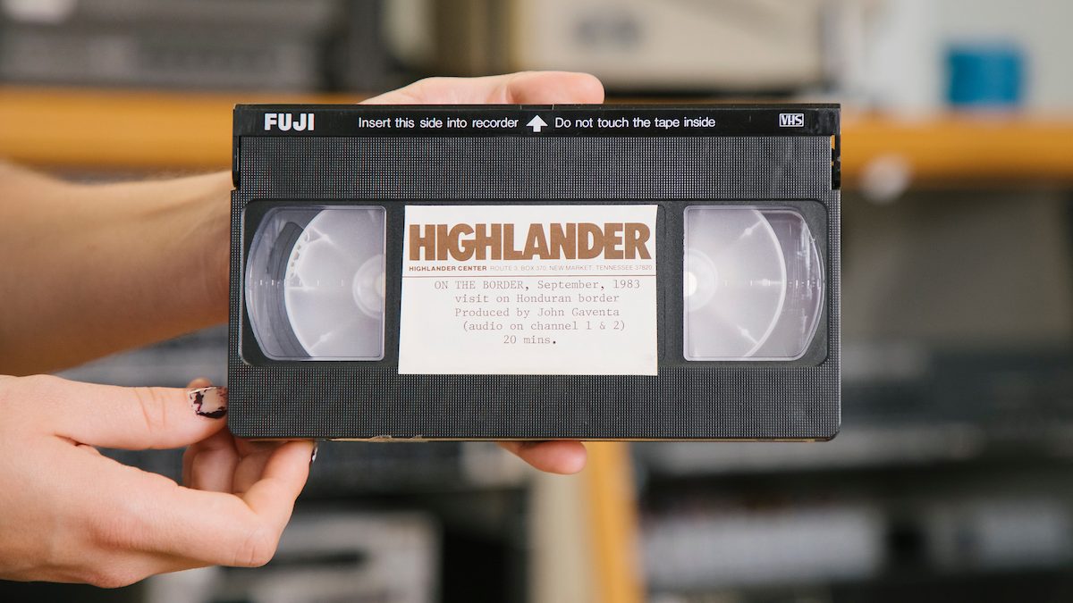 Librarian holding the Highlander video tape.