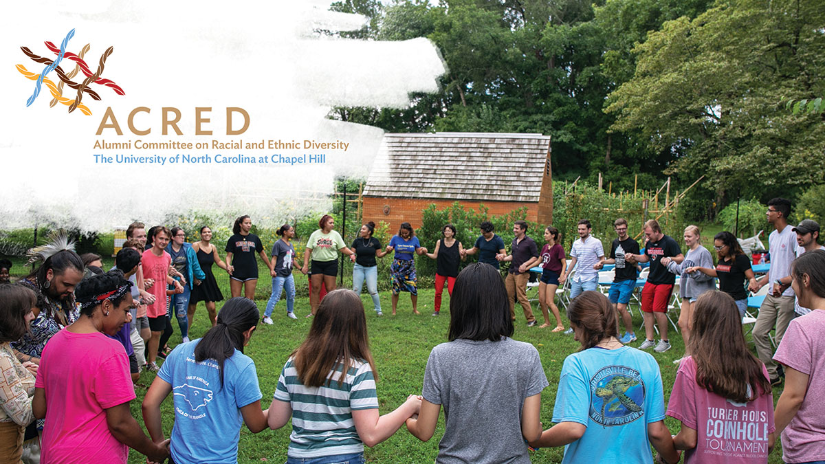 A group of people stand in a circle at the UNC American Indian Center. The ACRED logo is featured on the upper left-hand corner.