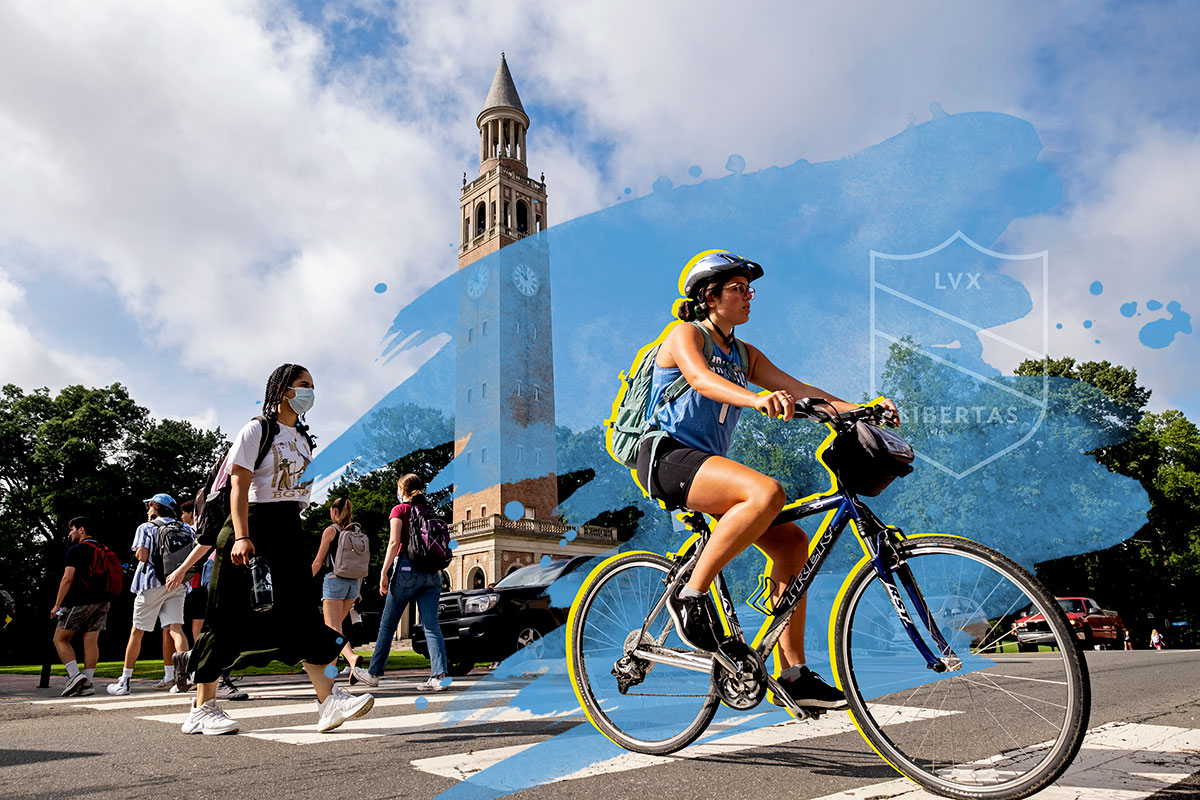 A student rides a bicycle in front of the Bell Tower at UNC-Chapel Hill.