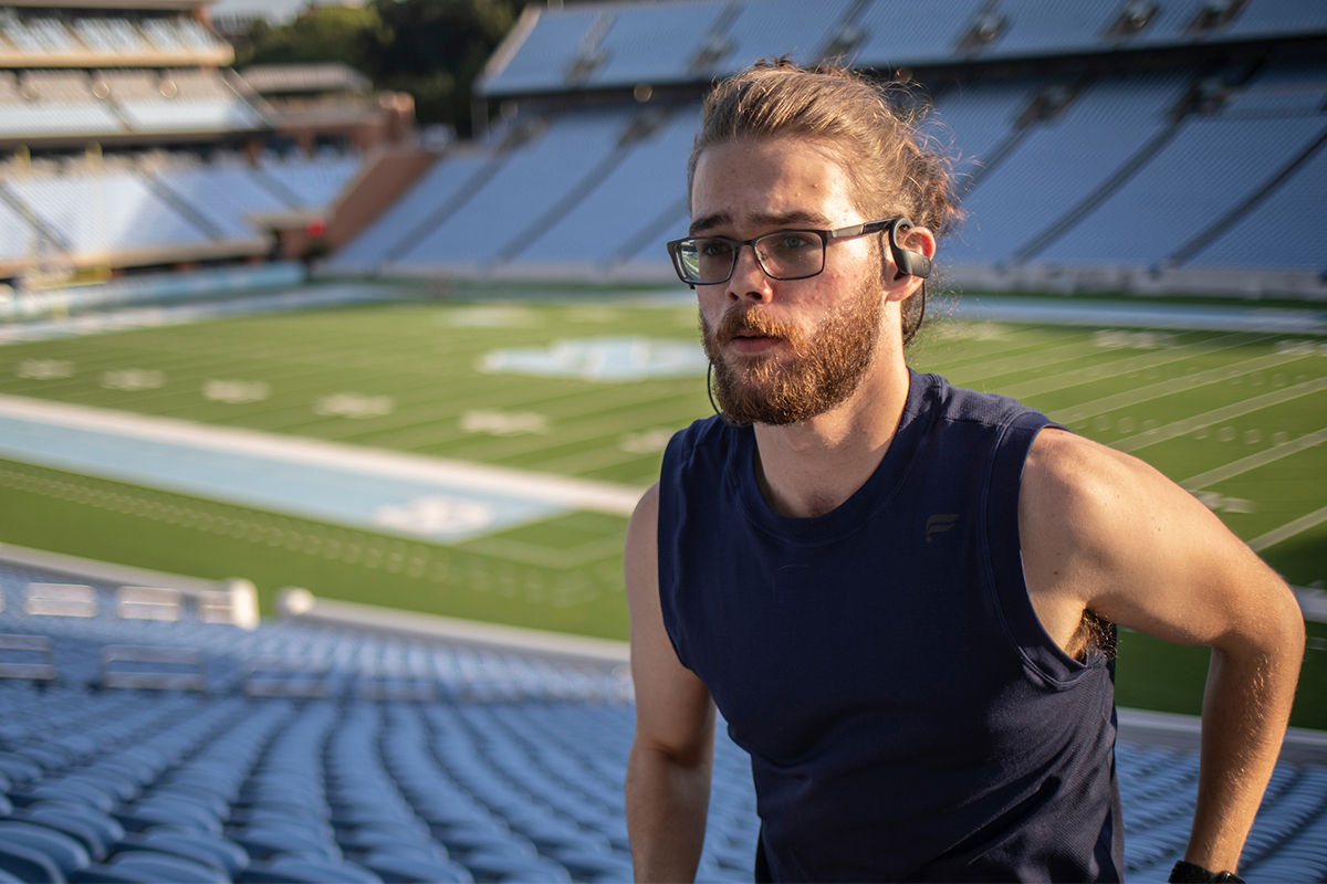 Portrait of Matthew Wood running up the stairs at Kenan Stadium