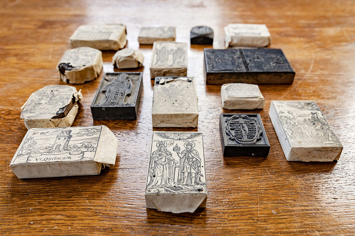 Blocks lying on a wooden table, each with a different image and scripture
