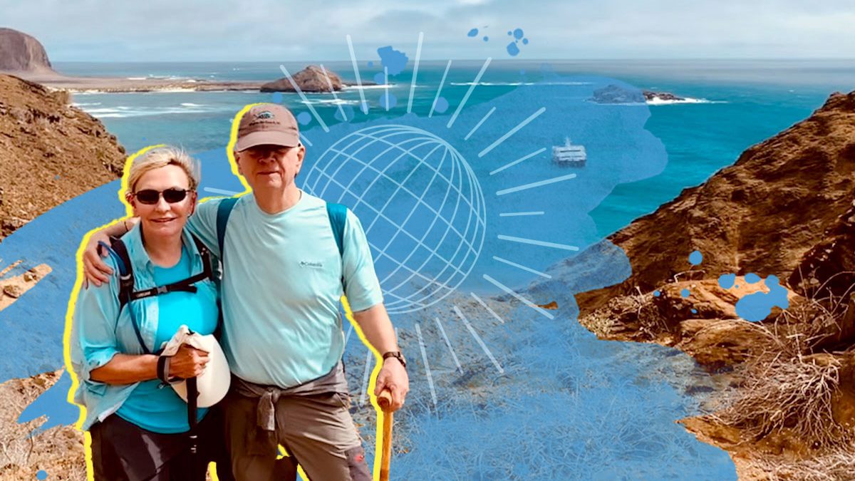 Bettie McKaig and Ross Vaughan pose in front of the ocean in the Galapagos