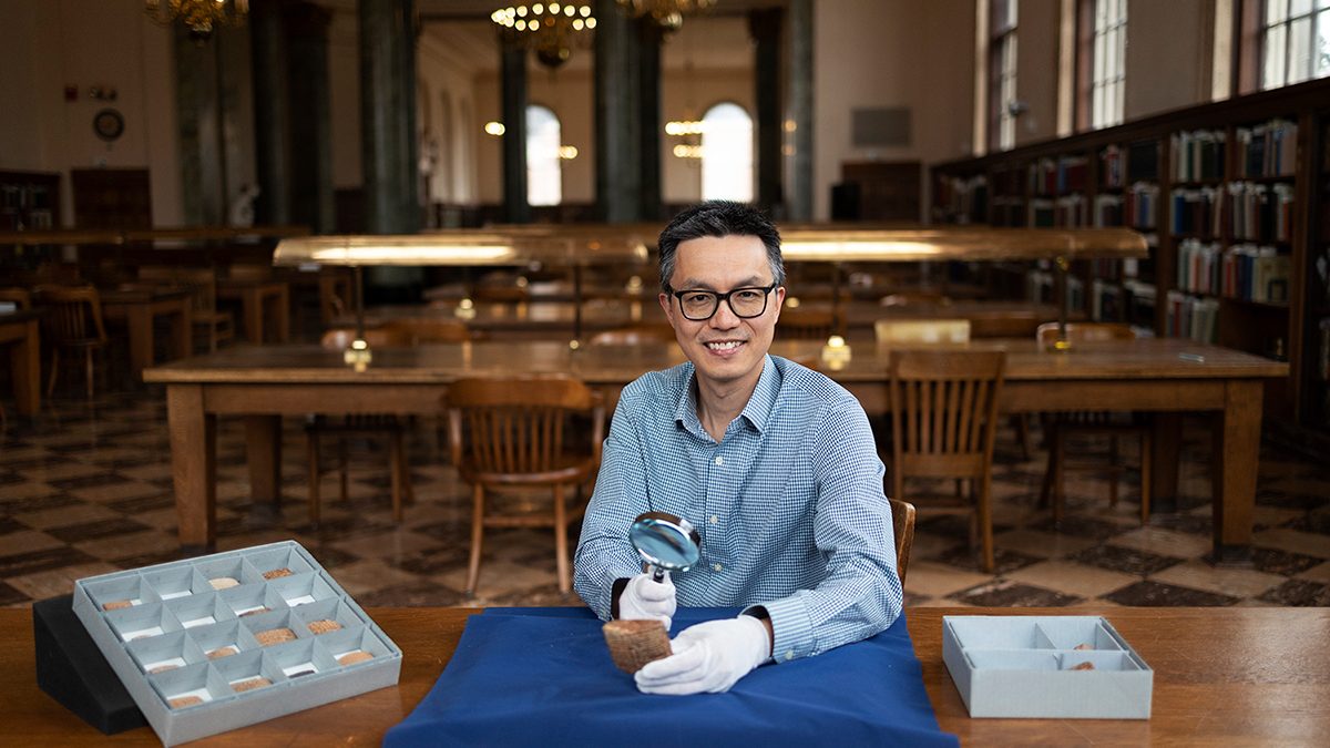 Lam in the Fearrington Reading Room with ancient cuneiform tablets.