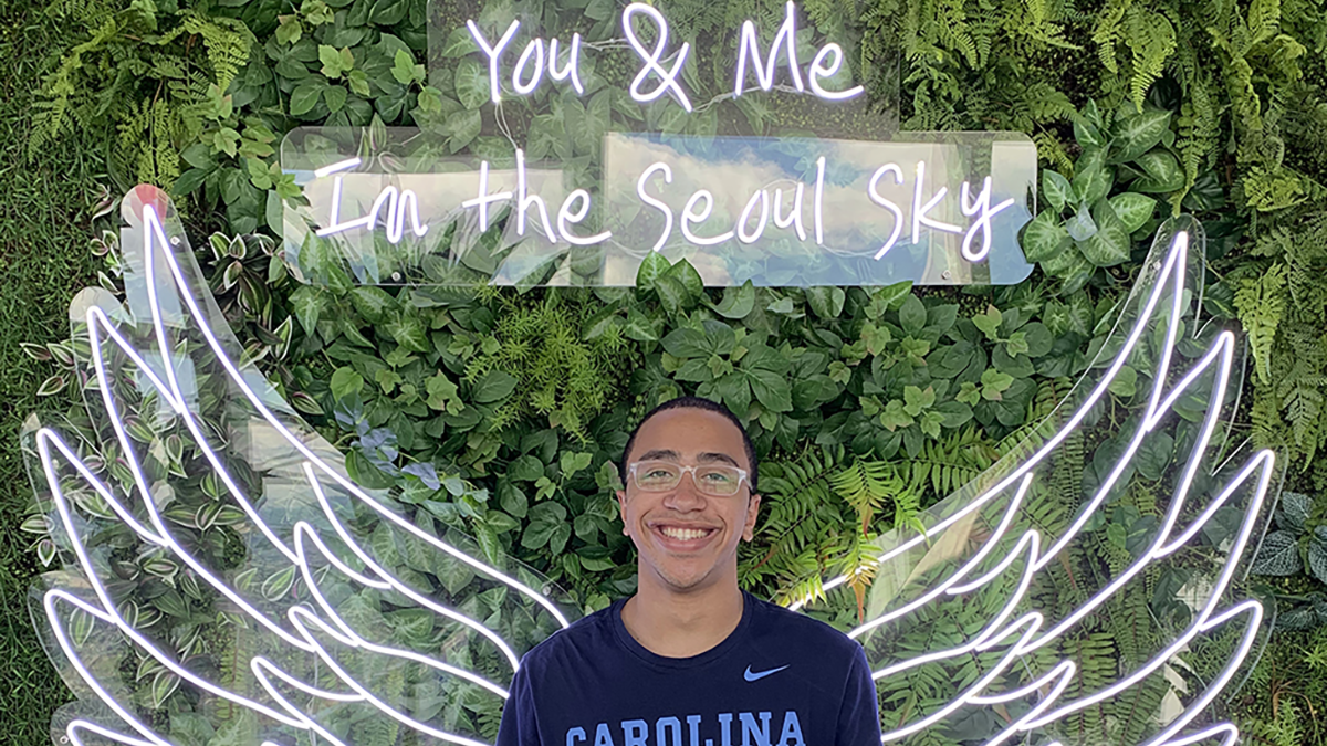 Tracy Ridley in front of a sign that reads