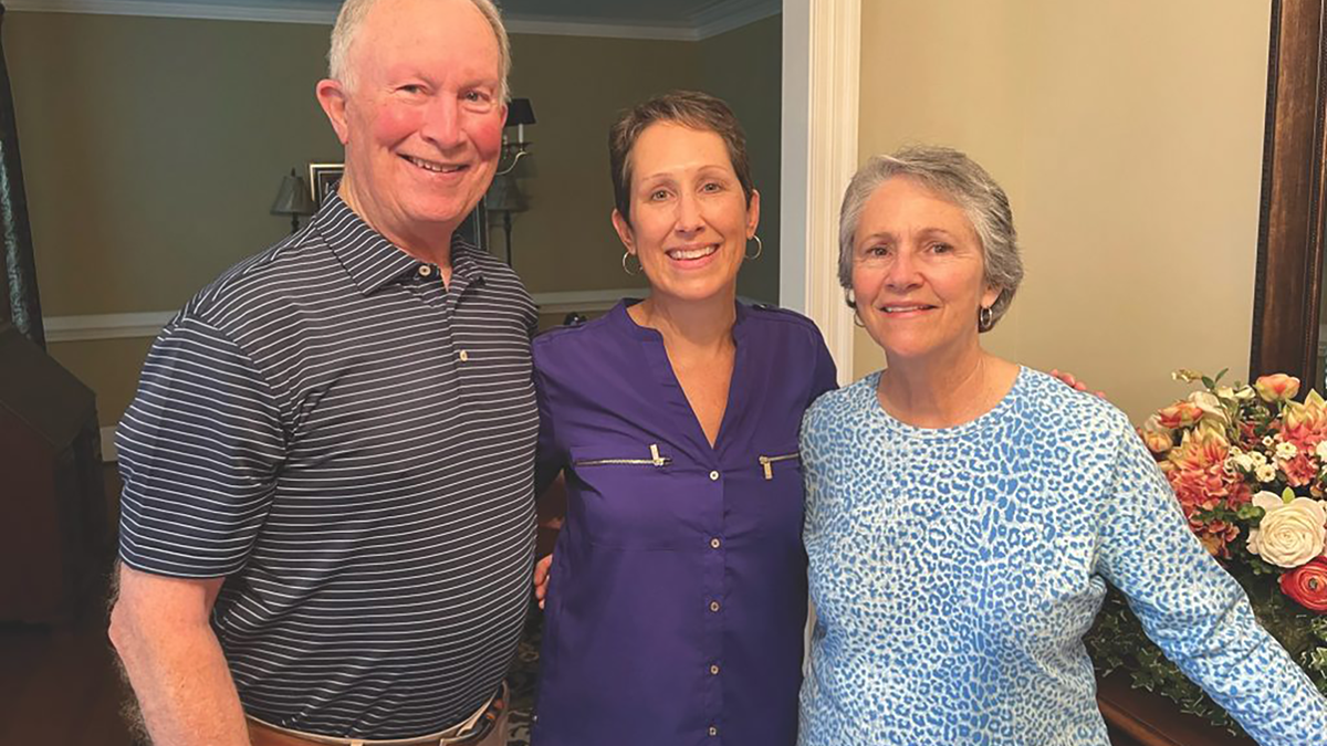 Tom, Wilson, and Nancy Chewning stand in their house.