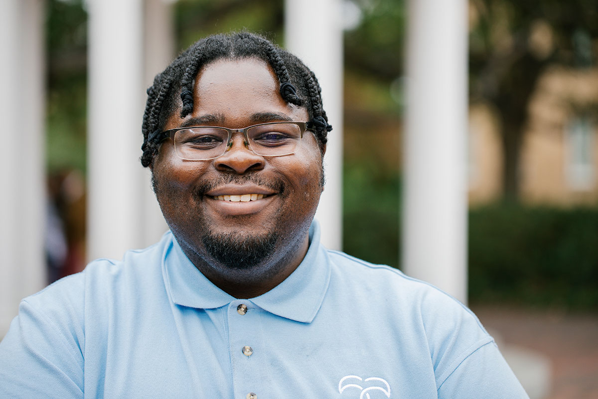 An up-close portrait of DeCarlos Hickson in front of the Old Well at UNC-Chapel Hill
