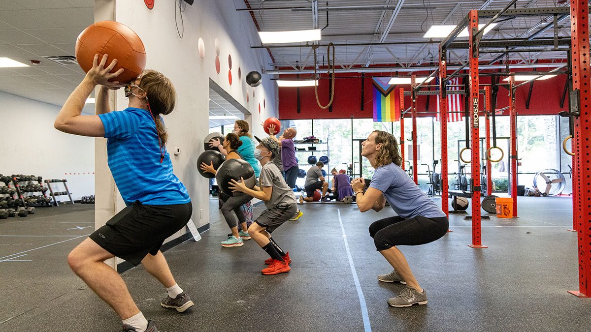 Kara Hume does squats with athletes in her adaptive fitness class