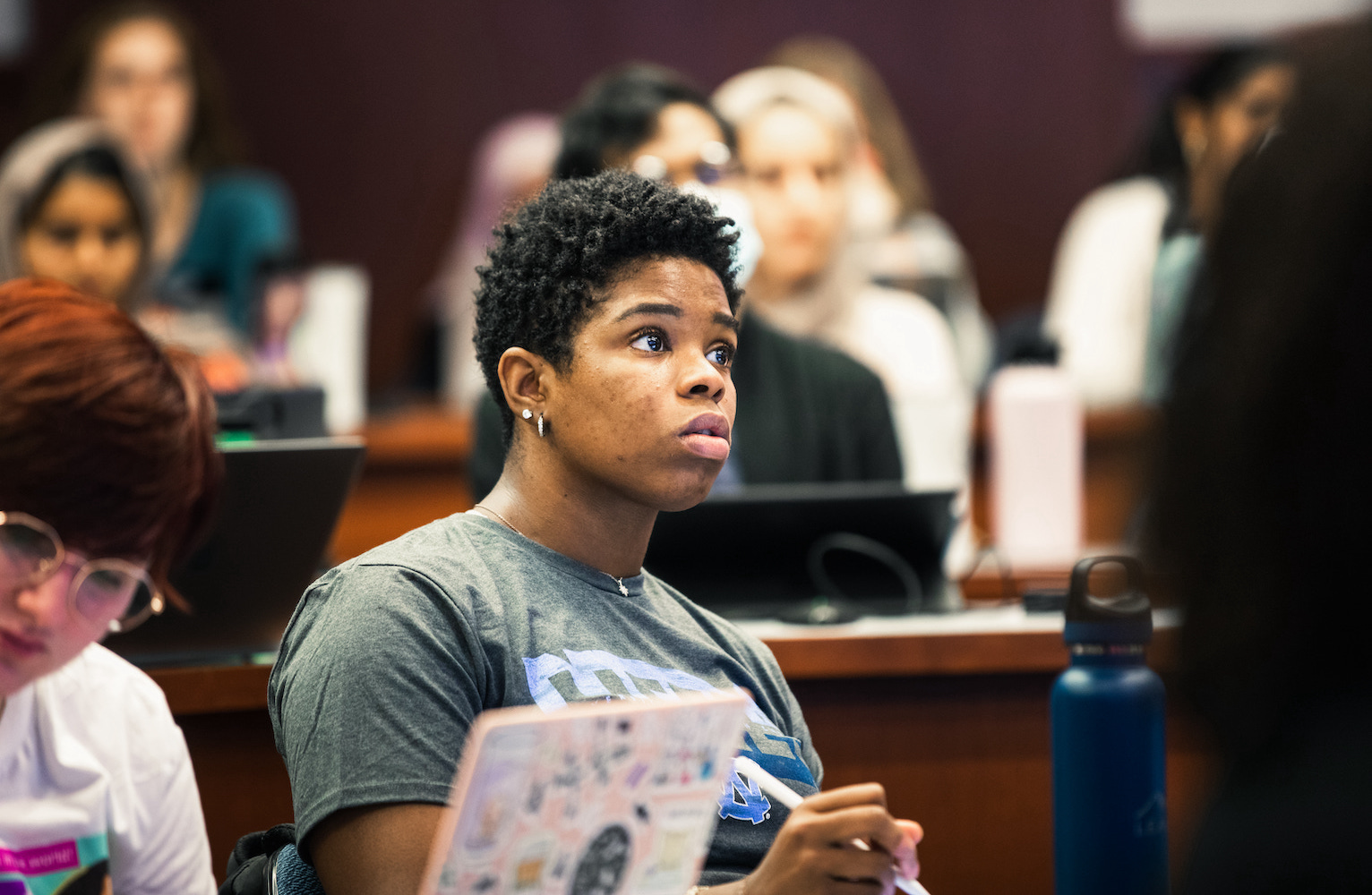 A UNC Eshelman School of Pharmacy student takes notes during class.