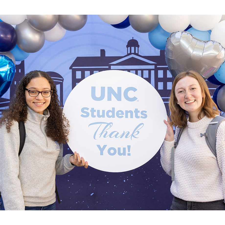 Carolina students hold up a sign thanking donors to UNC-Chapel Hill