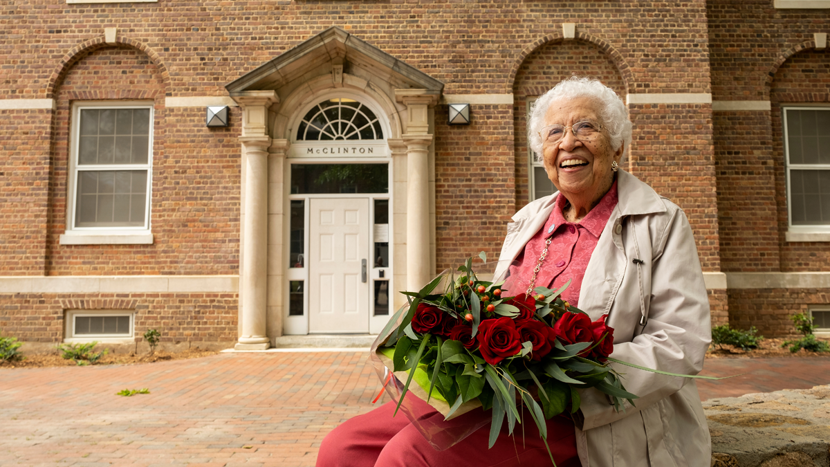 Hortense McClinton sits in front of the residence hall named after her