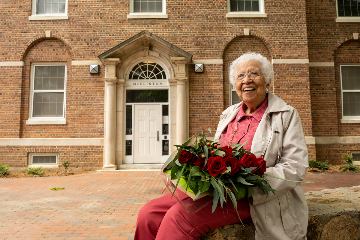 Hortense McClinton sits in front of the residence hall named after her