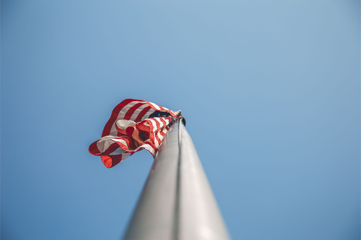 A US flag flies on a pole