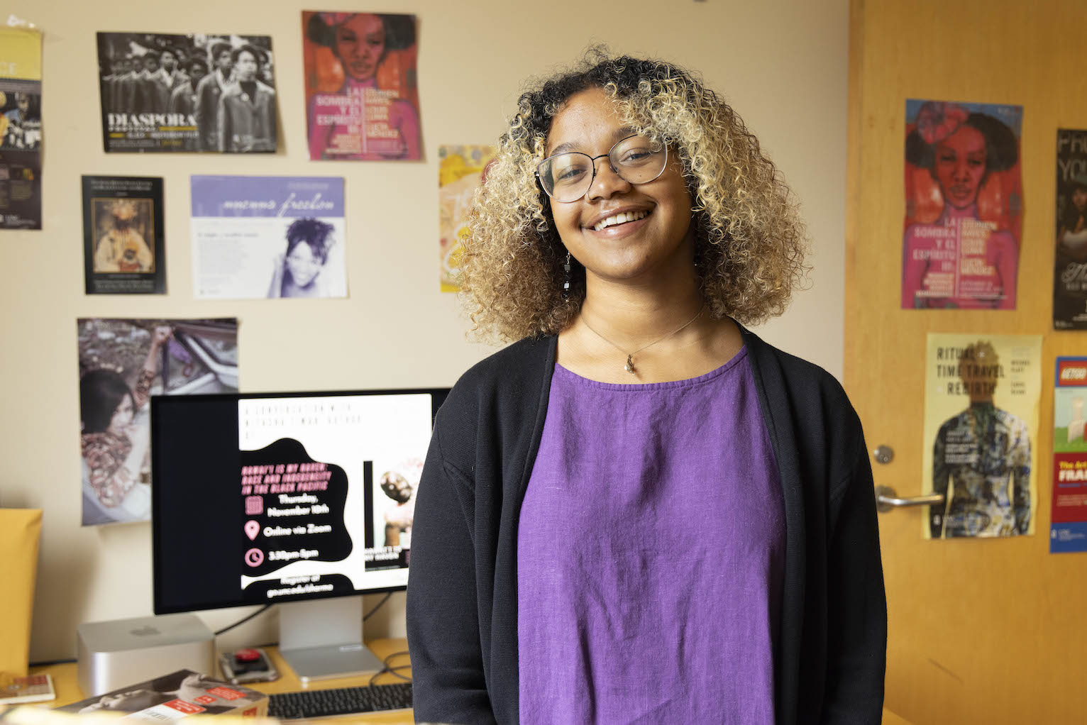 Selena Braye-Bulls smiles with posters in the background.