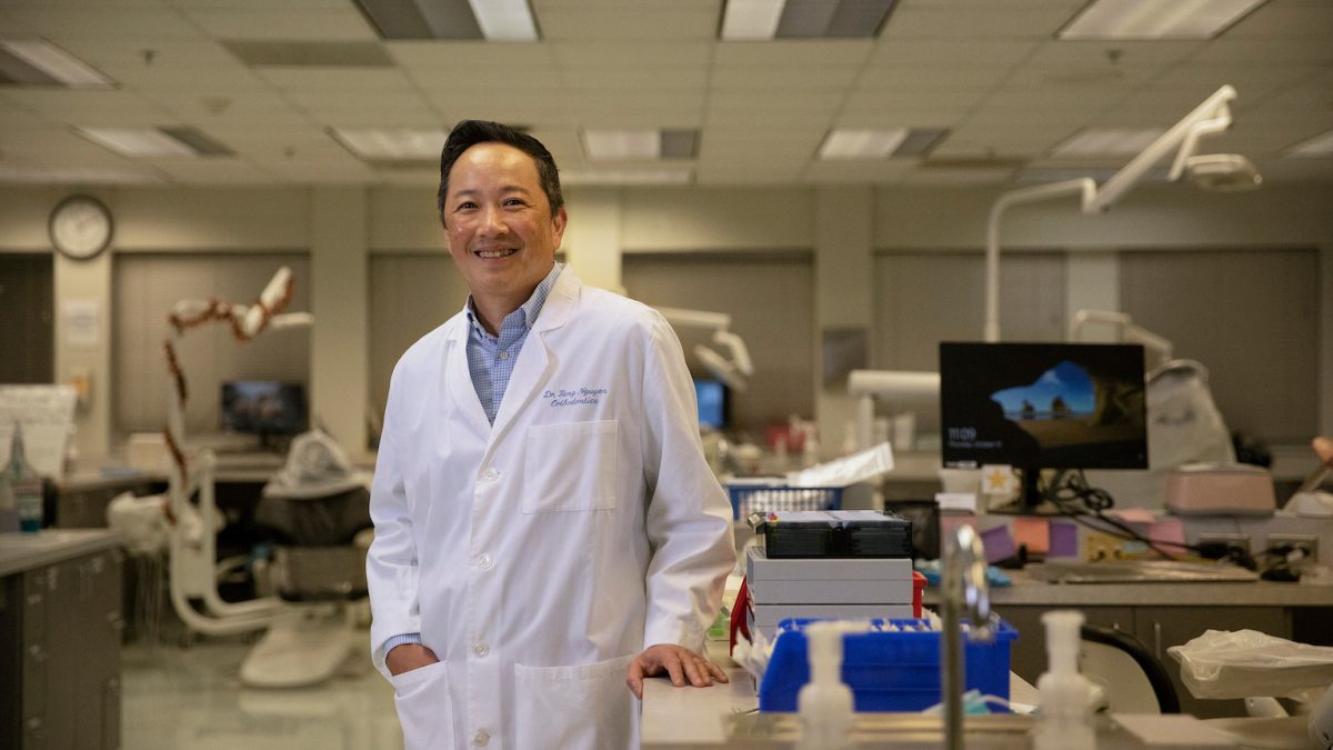 Dr. Tung Nguyen poses in a lab at the UNC Adams School of Dentistry.